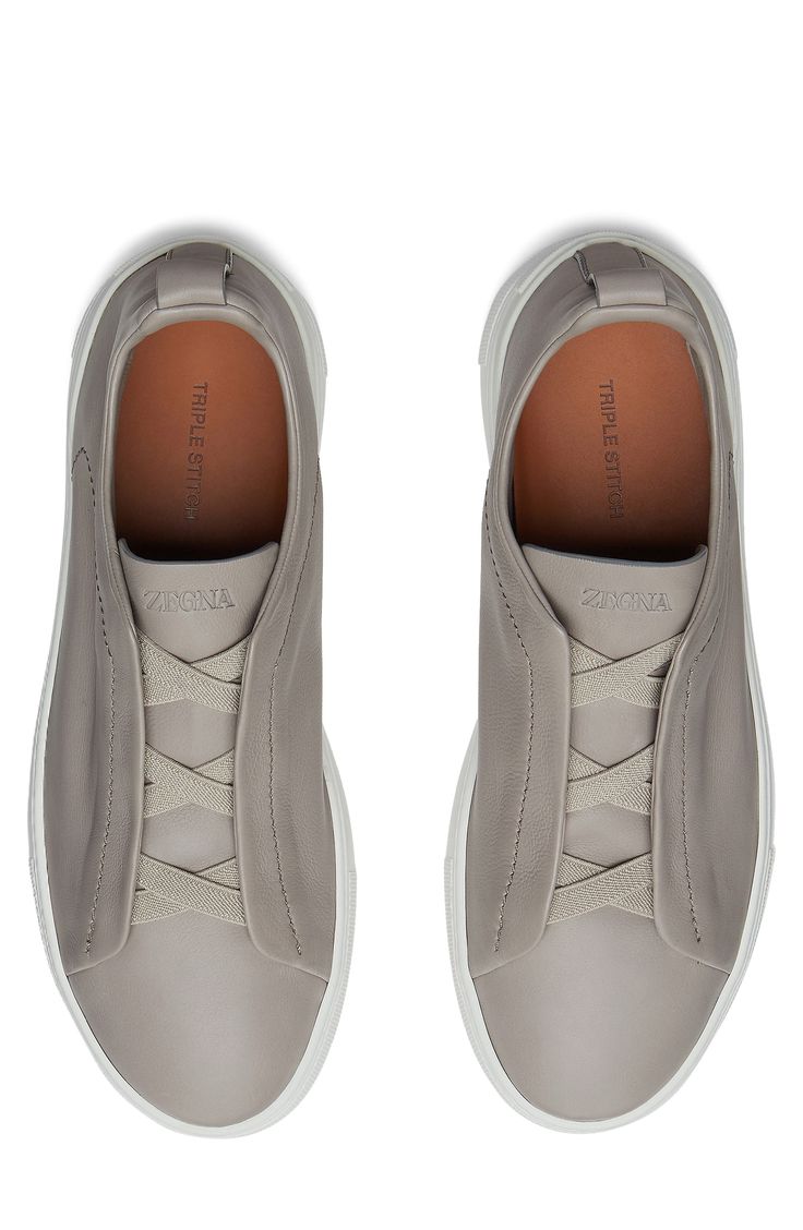 The Secondskin Triple Stitch sneaker features a glove-leather upper for mold-to-your-foot comfort and is mounted on an extralight rubber sole for a sleek look. The brand’s signature crossover elastic straps ensure an easy slip-on fit. Pull-on style with elastic laces Leather upper and lining/synthetic sole Made in Italy Designer Shoes Modern Leather Slip-on Sneakers With Vibram Sole, Functional Leather Slip-on Sneakers, Leather Low-top Slip-on Sneakers With Vibram Sole, Leather Slip-on Sneakers With Vibram Sole And Round Toe, Functional Low-top Leather Slip-on Sneakers, Functional Leather Low-top Slip-on Sneakers, Leather Slip-on Sneakers With Round Toe, Functional Leather Slip-on Sneakers With Round Toe, Leather Slip-on Sneakers With Vibram Sole