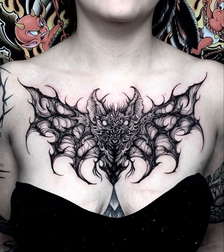 a woman with tattoos on her chest is posing for the camera