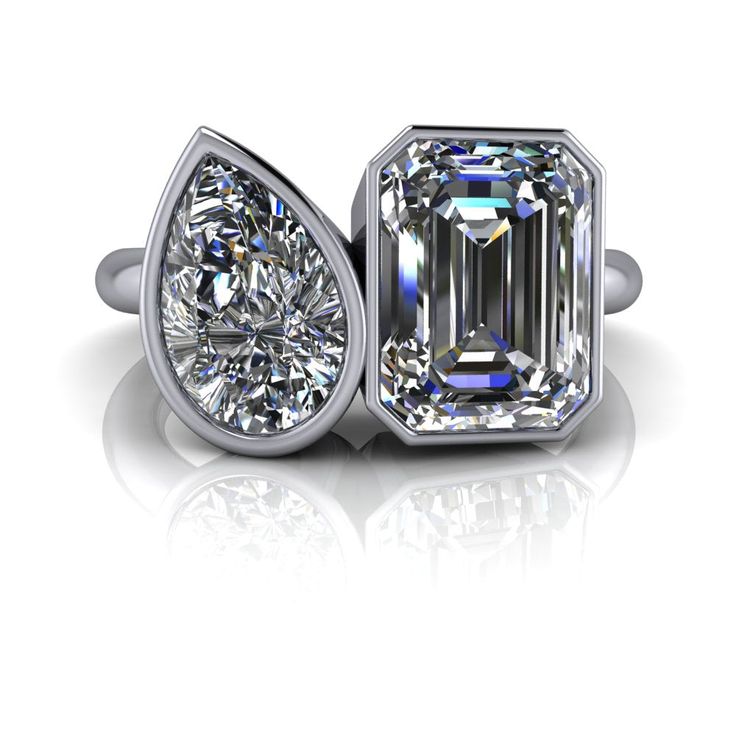 Toi Et Moi ring shown with a 9x7mm, 2.55 ct. emerald cut colorless moissanite, DEF Color, VVS clarity.9x6mm, 1.50 ct. pear colorless moissanite, DEF Color, VVS Clarity. **Band width 2.5mm, band thickness 2.5mm. *4.05 carat total weight. *Your moissanite stone arrives with a warranty card/certification of authenticity.*The ring is custom made just for you in your ring size and metal preference. *Please contact us prior to purchasing with any questions, we are happy to help. Mens Gemstone Rings, Rings Mens Wedding Bands, Moissanite Necklace, Forever One Moissanite, Moissanite Earrings, Dream Engagement Rings, Cubic Zirconia Earrings, Ring Crafts, Stone Engagement Rings