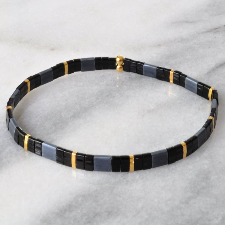 Like little works of art you can wear, these stretch tile bracelets — all in exclusive Libby & Smee patterns — are perfect on their own or in one of our curated sets. Stacking is strongly encouraged. style: BLACK SLATE glass and gold-plated tile beads stretch cords finished with gold-plated crimp covers lead-free and nickel-free comes in one 7" size to fit most wrists packaged in a clear resealing bag for storage and gift giving SAVE $15 when you buy a curated set or pick any three here: Lib Trendy Black Stackable Stretch Bracelet, Adjustable Flexible Black Bracelets, Adjustable Black Stackable Stretch Bracelet, Adjustable Black Bracelet, Tile Bracelet, Yellow Tile, Wood Bead Bracelet, Morse Code Bracelet, Pretty Beads