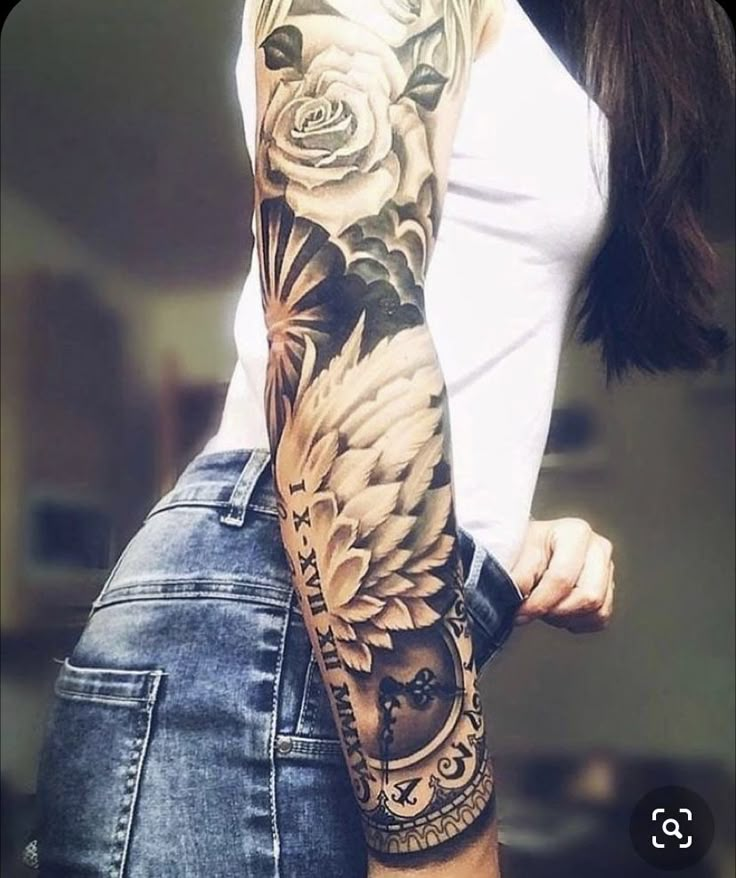 a woman with a full sleeve tattoo on her arm and shoulder is posing for the camera