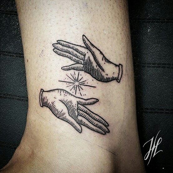 two hands touching each other on the side of a woman's leg with an arrow in it