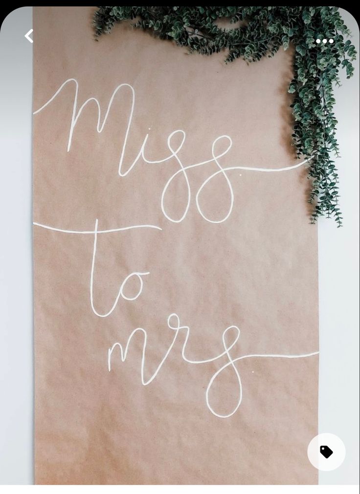 a piece of paper with the words miss to mrs written on it and a plant