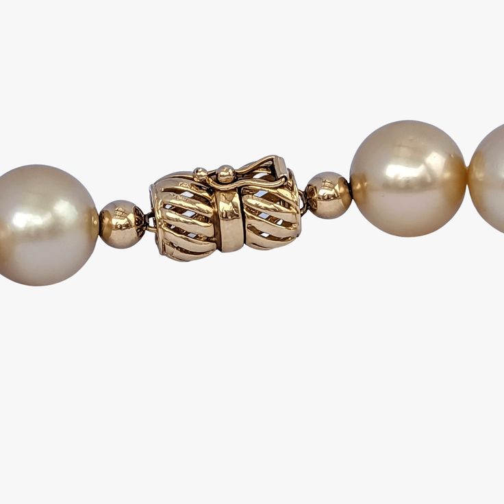 Indulge in the elegance and natural beauty of this stunning South Sea pearls necklace, featuring Golden South Sea pearls sourced from Indonesia. Crafted with meticulous attention to detail, this necklace is a testament to exceptional craftsmanship and exquisite materials.Secured with a 14K yellow gold 'twist and lock' clasp, the necklace measures 17.25 inches (43.5cm) in length, draping gracefully around the neckline. The weight of 95.7g adds a substantial feel and underscores the luxurious qual Luxury Pearl Necklace With 17 Jewels, Elegant Round Pearl Necklace With High Luster, Elegant High Luster Pearl Necklace, Luxury Single Strand Yellow Gold Pearl Necklace, Elegant Formal Pearl Necklace With High Luster, Timeless High Luster Necklace For Formal Occasions, Elegant High Luster Pearl Necklace For Formal Occasions, Luxury Akoya Pearl Bracelet For Formal Occasions, Elegant Pearl White Necklace With High Luster