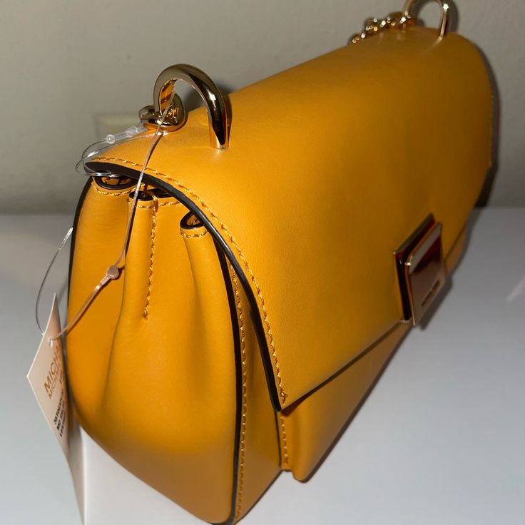 Beautiful Leather Bag With A Bright Orange Color . Brand New With Tags! Classic Yellow Office Bag, Yellow Crossbody Satchel For Office, Evening Flap Shoulder Bag With Branded Hardware, Gold Office Shoulder Bag With Branded Hardware, Elegant Yellow Bag With Branded Hardware, Elegant Yellow Bags With Branded Hardware, Modern Yellow Satchel With Gold-tone Hardware, Yellow Shoulder Bag With Branded Hardware For Travel, Modern Gold Flap Bag With Branded Hardware