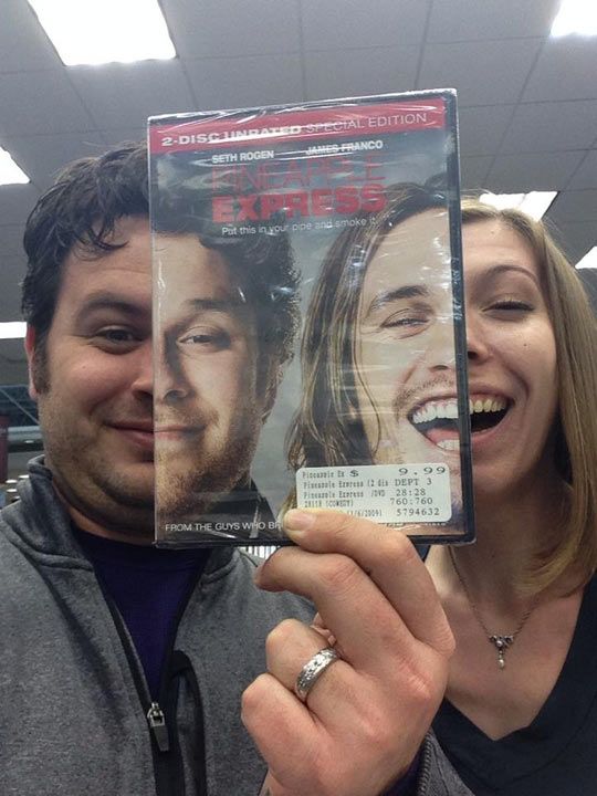 a man and woman holding up a dvd in front of their face with the words express on it