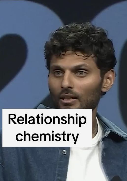 a man standing in front of a microphone with the words'relationship chemistry'written on it