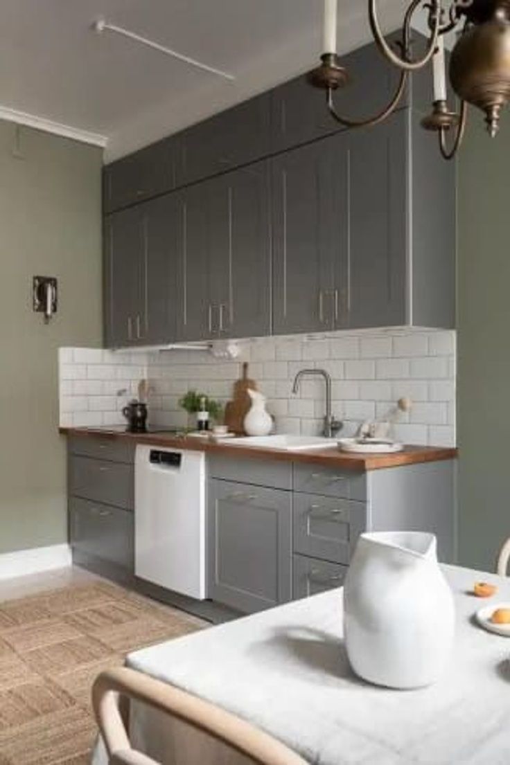 a kitchen filled with lots of counter space next to a dining room table and chairs