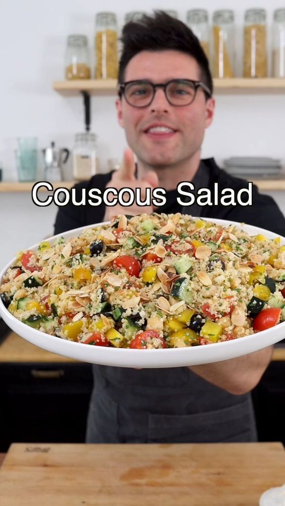 a man holding up a large platter filled with food