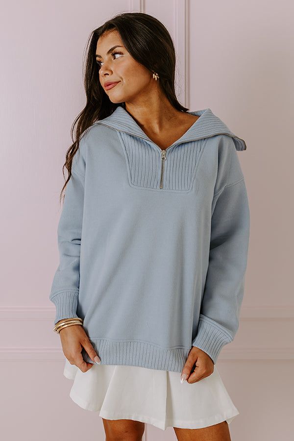 - Go on a latte run in this trendy top! - Warm unlined material - A zip down v-cut neckline with a ribbed texture - Long, loose sleeves with ribbed cuffs - A relaxed silhouette that ends in a ribbed hemline Blue V-neck Tops With Ribbed Cuffs, Trendy Blue Top With Ribbed Collar, Blue Long Sleeve Top With Zipper Closure, Light Blue Lounge Top With Ribbed Cuffs, Casual Tops With Zipper Closure For Loungewear, Oversized Blue Ribbed Top, Oversized Half-zip Spring Tops, Spring Half-zip Top With Relaxed Fit, Spring Relaxed Fit Half-zip Top