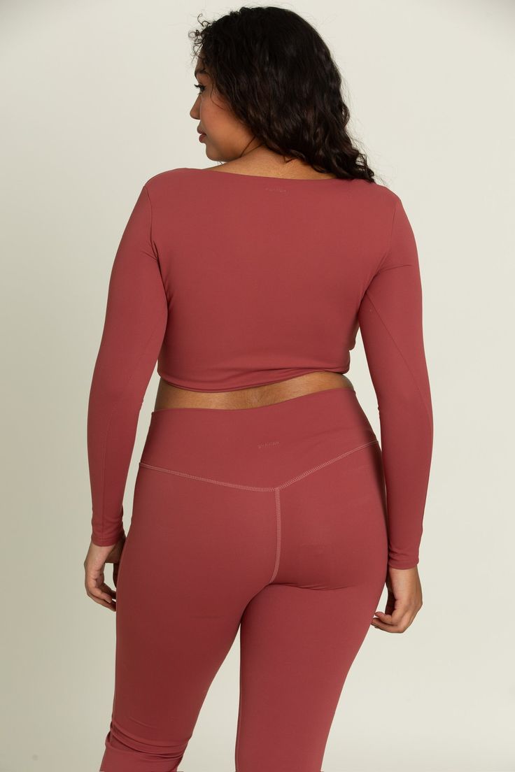 Pale Red Square Neck Long Sleeve Top is the year round staple you've been missing. It features a flattering square neckline to make any look more sophisticated and built-in removable padding for your preferred amount of support. Pair with our Pale Red Flare Yoga Pants for the perfect set. Versatile Fitted Red Tops, Square Neck Bra Friendly Solid Top, Red Fitted Top With Square Neck, Bra-friendly Solid Color Square Neck Top, Fitted Square Neck Top Bra Friendly, Stretch Square Neck Tops Bra Friendly, Stretch Square Neck Bra Friendly Tops, Bra Friendly Stretch Square Neck Tops, Red Fitted Crop Top For Winter