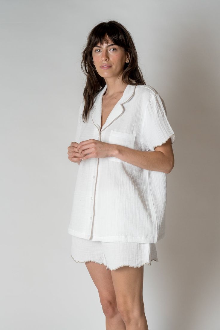 FINAL SALE The Alaia Pajama Set is made with 100% organic combed cotton, these are lightweight, comfy, and sustainable, making them the perfect addition to any sleepwear collection. With a unique scalloped trim for a touch of sophistication. Relaxed silhouette short sleeve Button front One chest pocket Scalloped edges at the sleeve and bottom of shorts Drawstring waist Kristen is 5'9" and wearing a size S/MSizes S/M and L/XL. Short Pj Set, Scalloped Trim, Scalloped Edges, Pj Sets, Combed Cotton, Chest Pocket, Drawstring Waist, Pajama Set, Final Sale