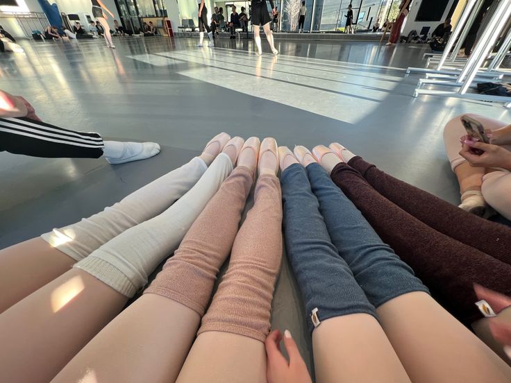 several women sitting on the floor with their legs crossed