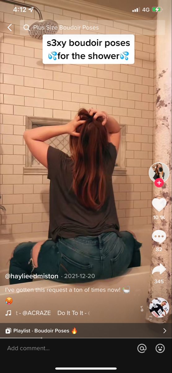 a woman sitting on the edge of a bathtub with her head in her hands