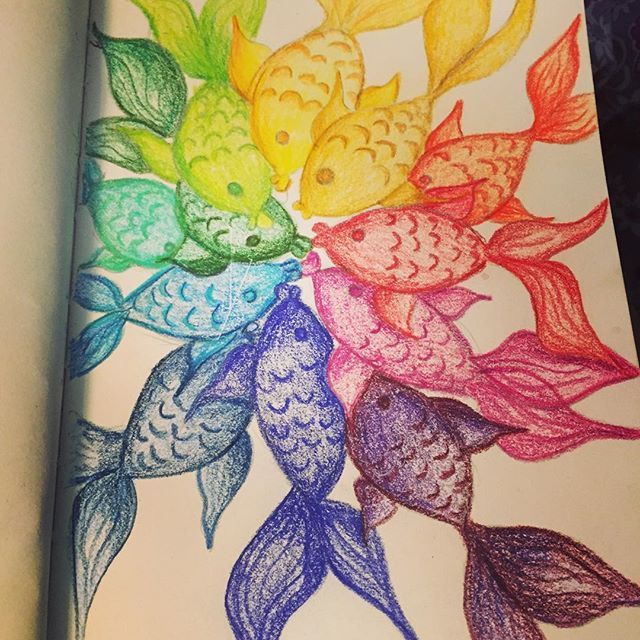 an open book with colored fish on it