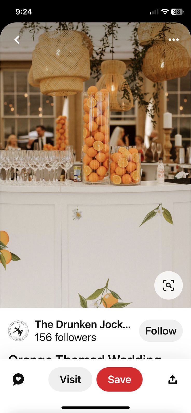 oranges are arranged on the bar in front of wine glasses and chandeliers