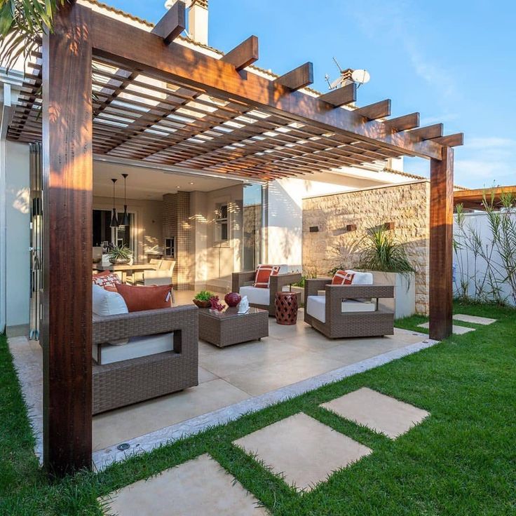 an outdoor living area with couches and tables