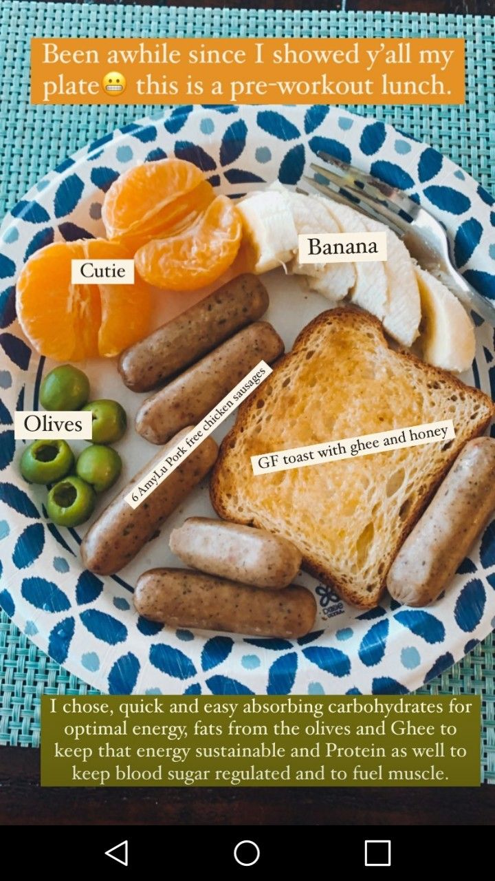 a plate with bread, oranges and other food on it