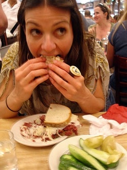 a woman sitting at a table with food in front of her