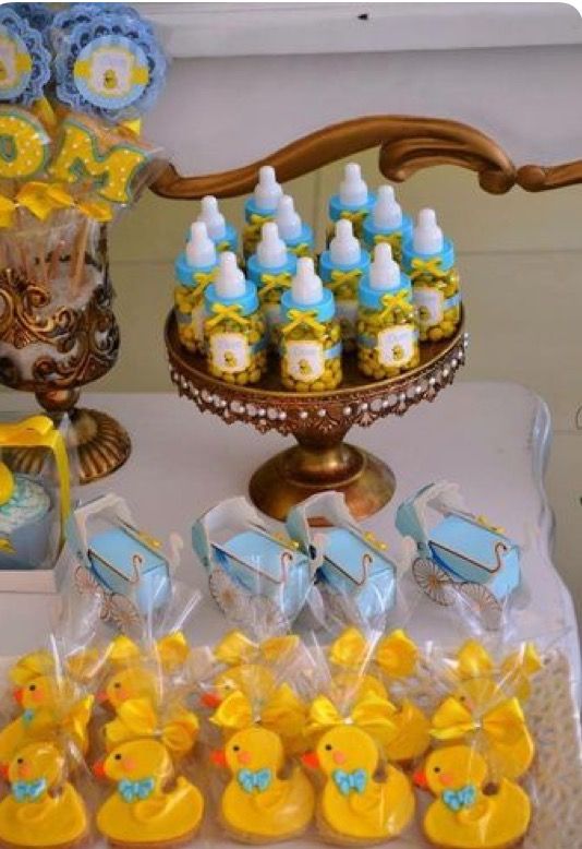 baby shower items displayed on a table with blue and yellow decorations