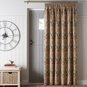 a living room with a clock on the wall next to a door and window curtain