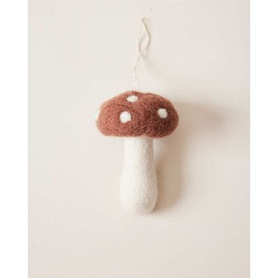 a mushroom ornament hanging on a wall