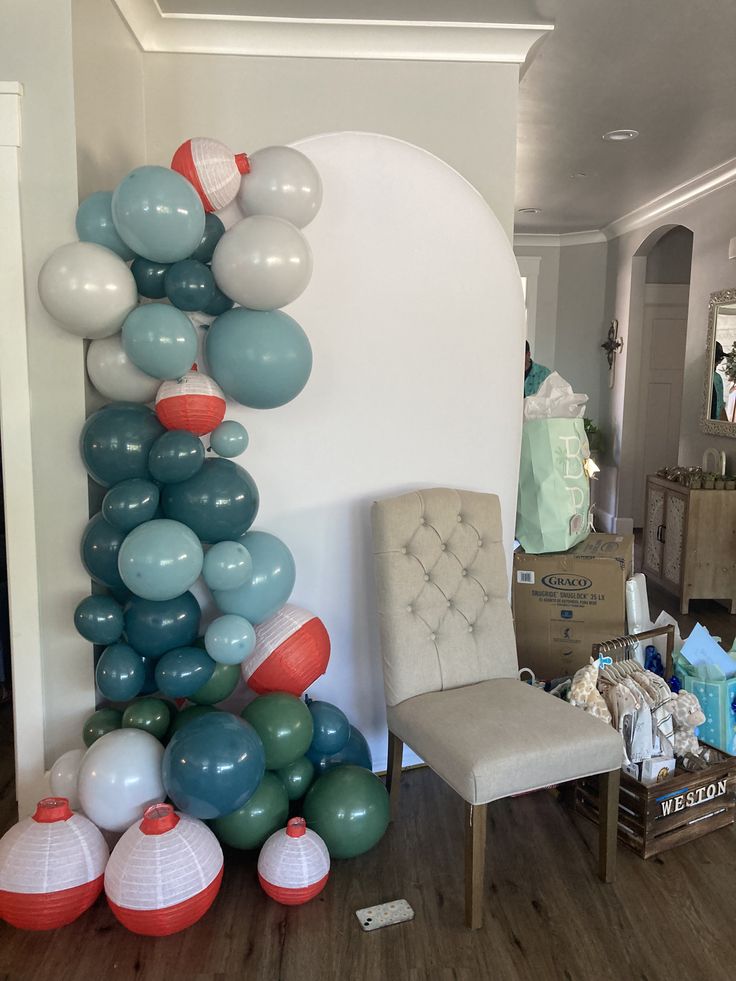 the balloon arch is decorated with blue, red and white balloons