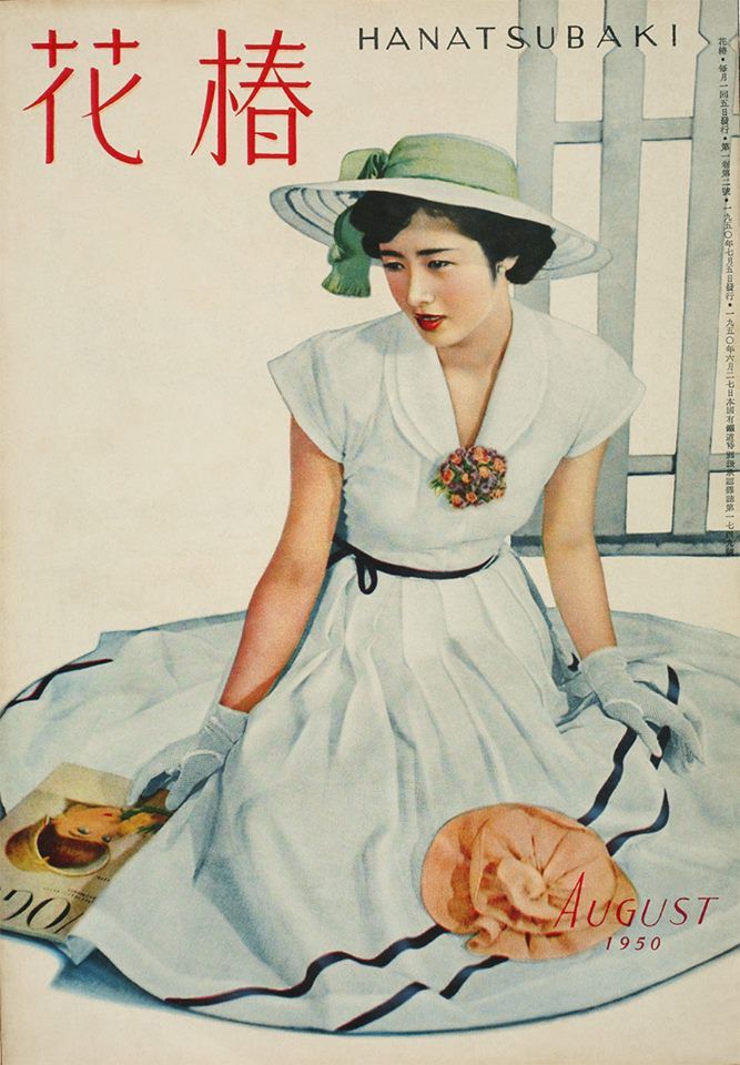 a woman in a white dress and hat is sitting on the ground with an orange