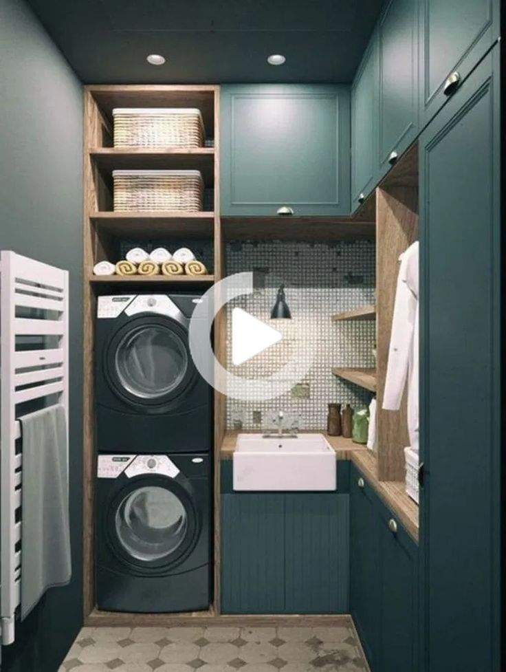 a washer and dryer in a small room with blue walls, cabinets and flooring