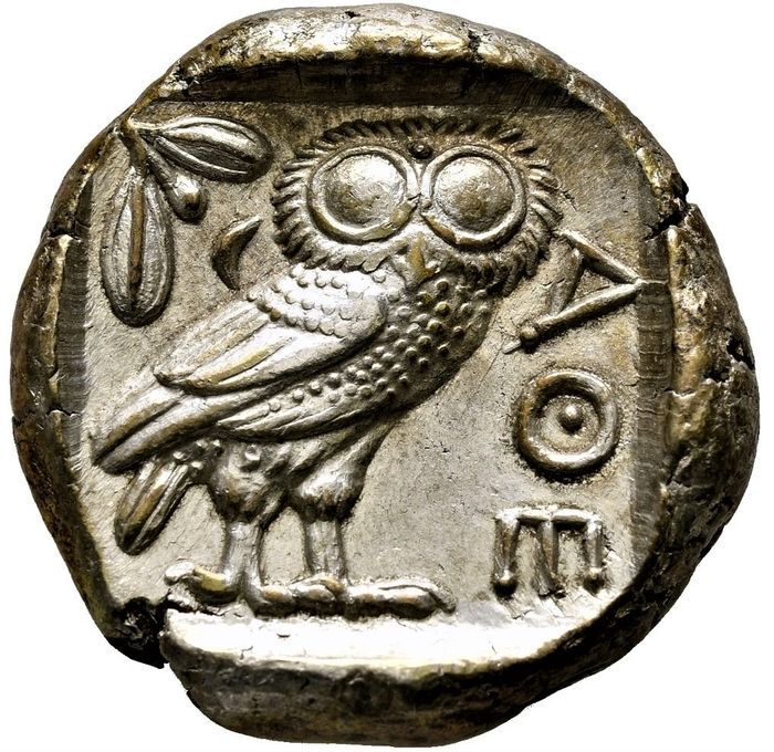 an ancient coin with an owl on it