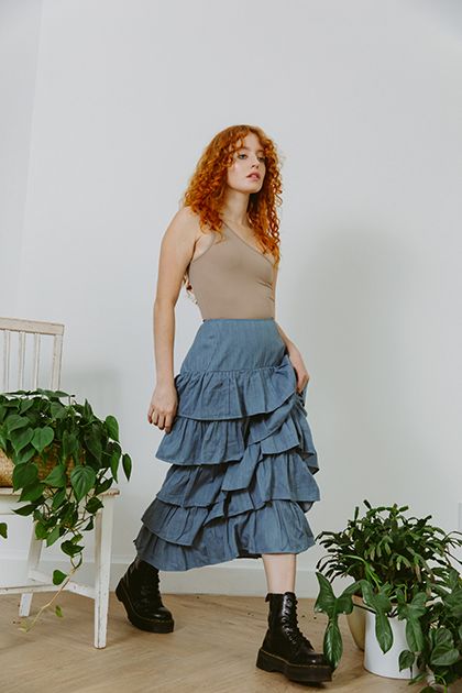 Ready to ship. Eco Denim Our beautiful palace midi skirt features ruffles that cascade down creating a very romantic, yet slimming fit. Beautifully made, with the perfect fit at the waist. Eco denim is dyed with eco friendly practices in India. Hand wash or eco wash recommended. As this denim has not been treated with a sealer we recommend that you pre-wash it at home, we did this to protect the environment. All of our collection garments have been produced ethically with eco consciousness in mi Chic Ruffled Cotton Denim Skirt, Chic Cotton Denim Skirt With Ruffles, Summer Asymmetrical Dark Wash Skirt, Dark Wash Asymmetrical Skirt For Summer, Fitted Denim Tiered Ruffled Skirt, Spring High Waist Ruffled Denim Skirt, Spring Asymmetrical Dark Wash Skirt, Spring Dark Wash Asymmetrical Skirt, High Waist Ruffled Cotton Denim Skirt