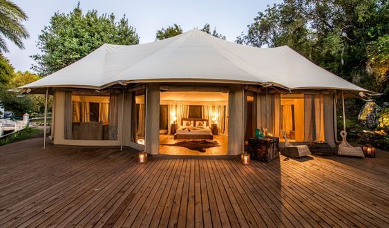 a large white tent sitting on top of a wooden deck