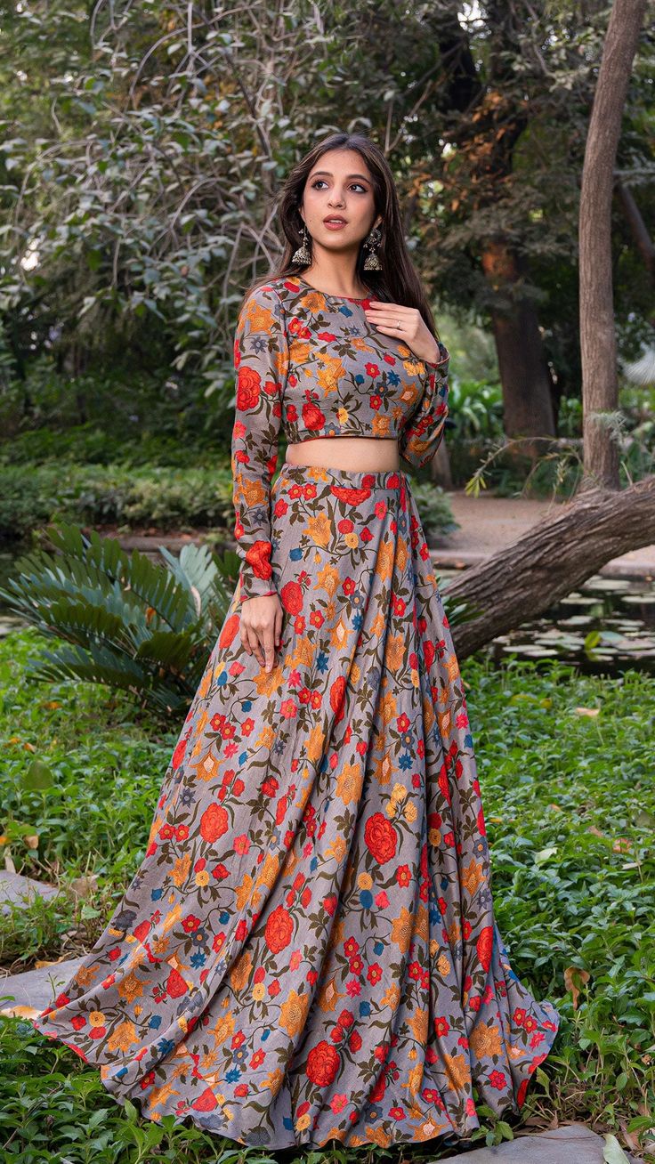 Grey raw silk printed lehenga set comes with closed neck blouse which features full sleeves and closed back with hook-eye opening. Organza dupatta is embellished with fabric borders. Color - Grey. Fabric - Printed Raw Silk. Number of components - 3. Can be bought without dupatta as well. Measurements in the size chart Cheap Lehenga With Padded Blouse, Cheap Lehenga With Padded Blouse For Women, Cheap Art Silk Choli For Eid, Festive Long Sleeve Cheap Choli, Bohemian Chanderi Palazzo Set With Long Sleeves, Bohemian Long Sleeve Chanderi Palazzo Set, Anarkali Palazzo Set With Printed Motifs For Reception, Silk Lehenga With Printed Motifs For Reception, Reception Lehenga With Printed Motifs Semi-stitched