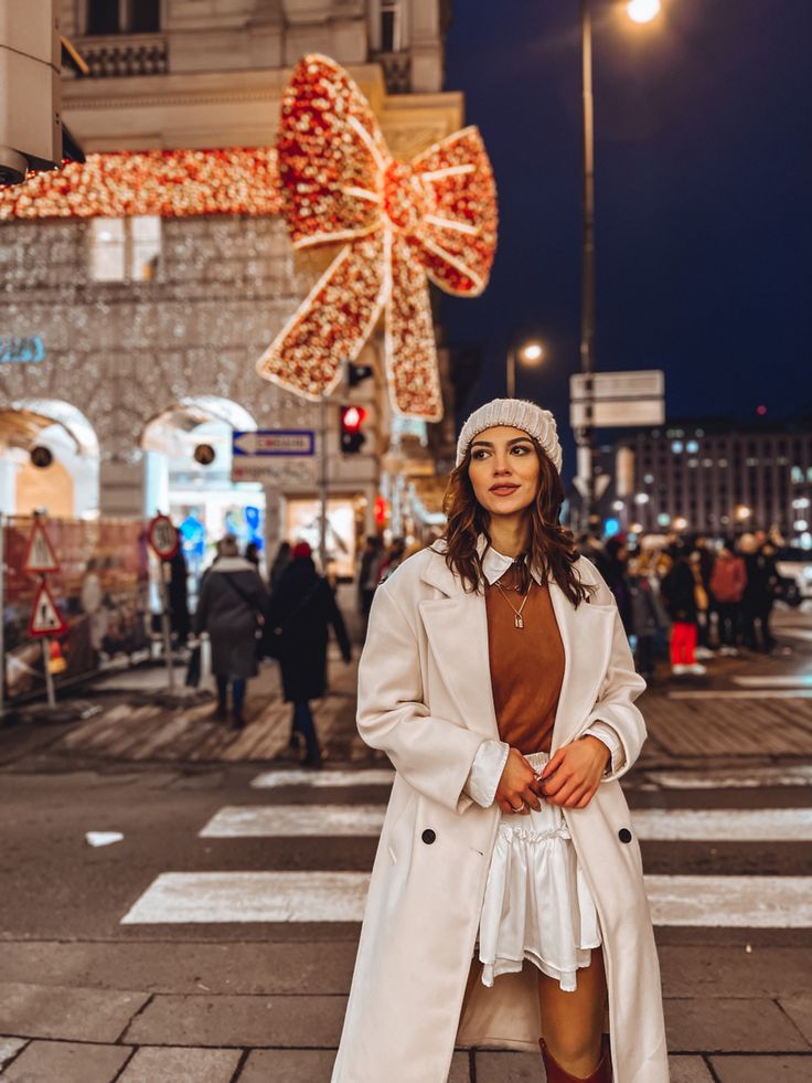 a woman standing in the middle of a cross walk