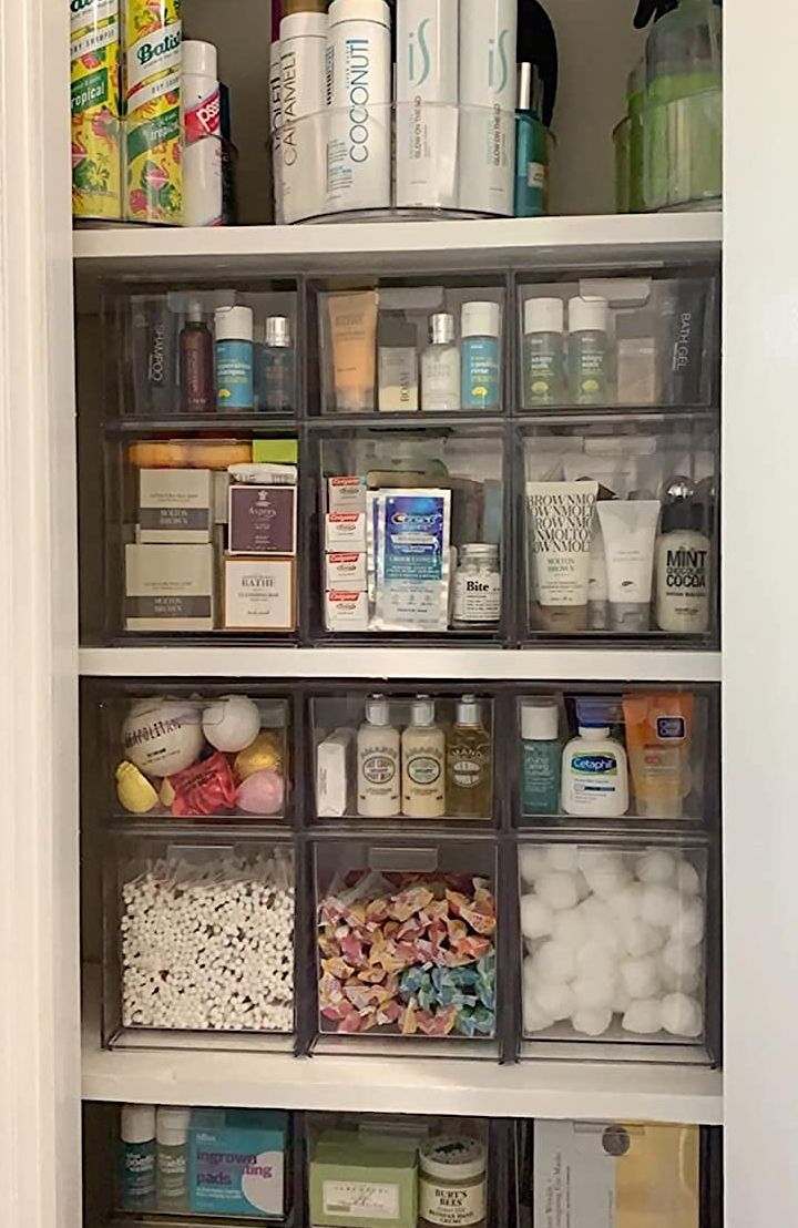 an organized pantry with clear bins filled with food