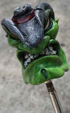 a close up of a green frog statue