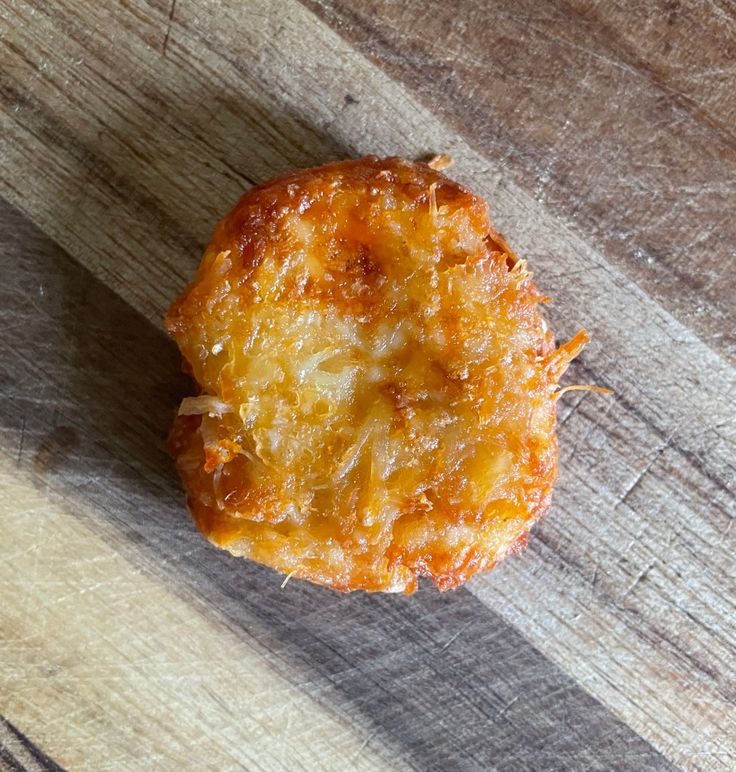 a piece of food sitting on top of a wooden table