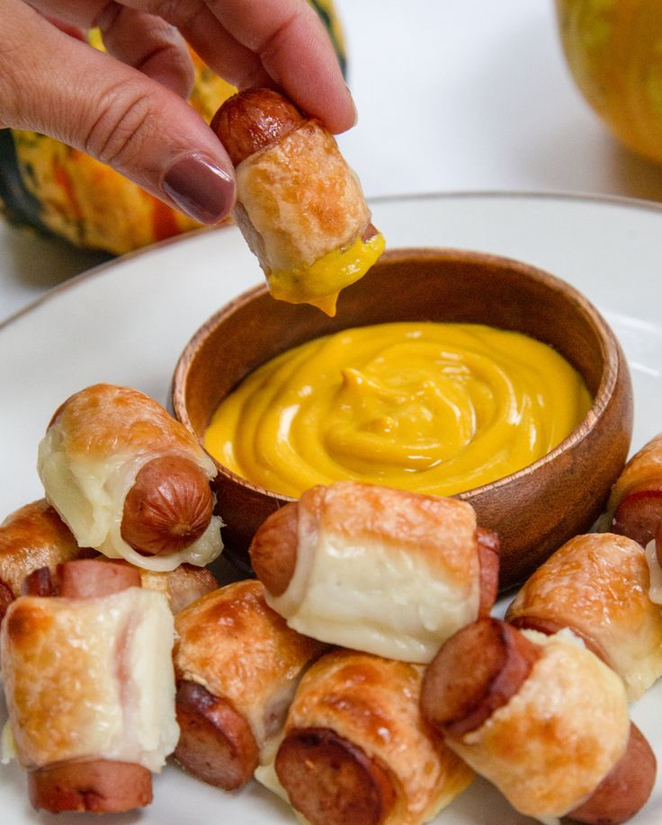 a person dipping some food into a bowl