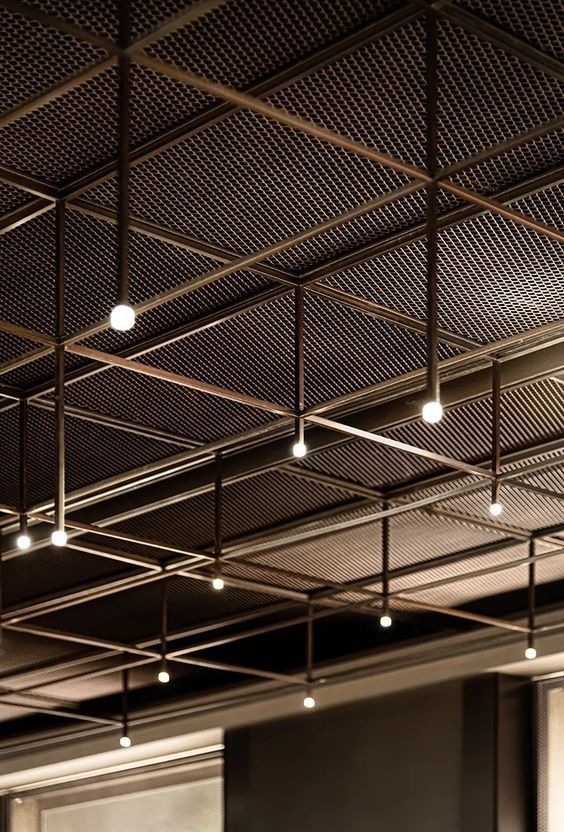 the ceiling in an office building is covered with metal grids