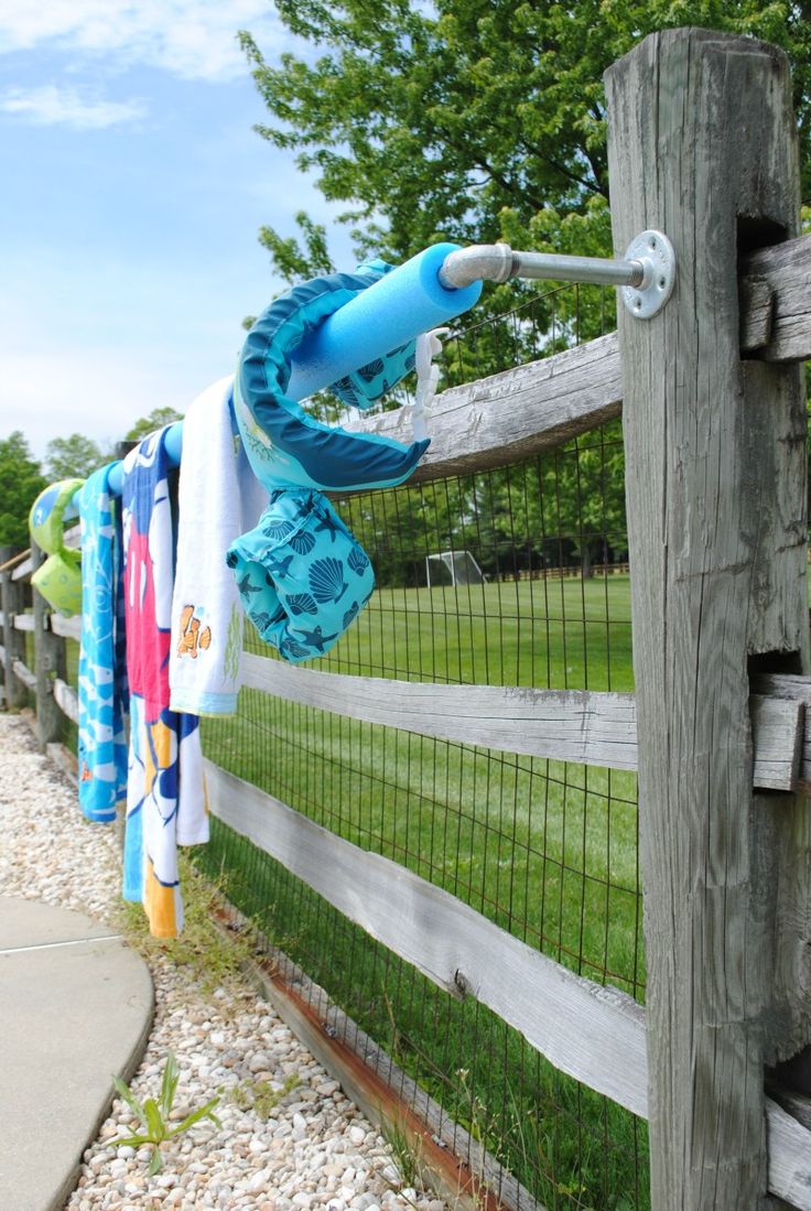 towels are hanging on the fence and drying