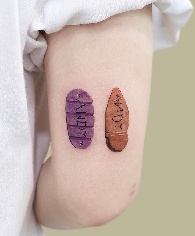 two pairs of shoes with happy written on their legs, one is purple and the other is brown