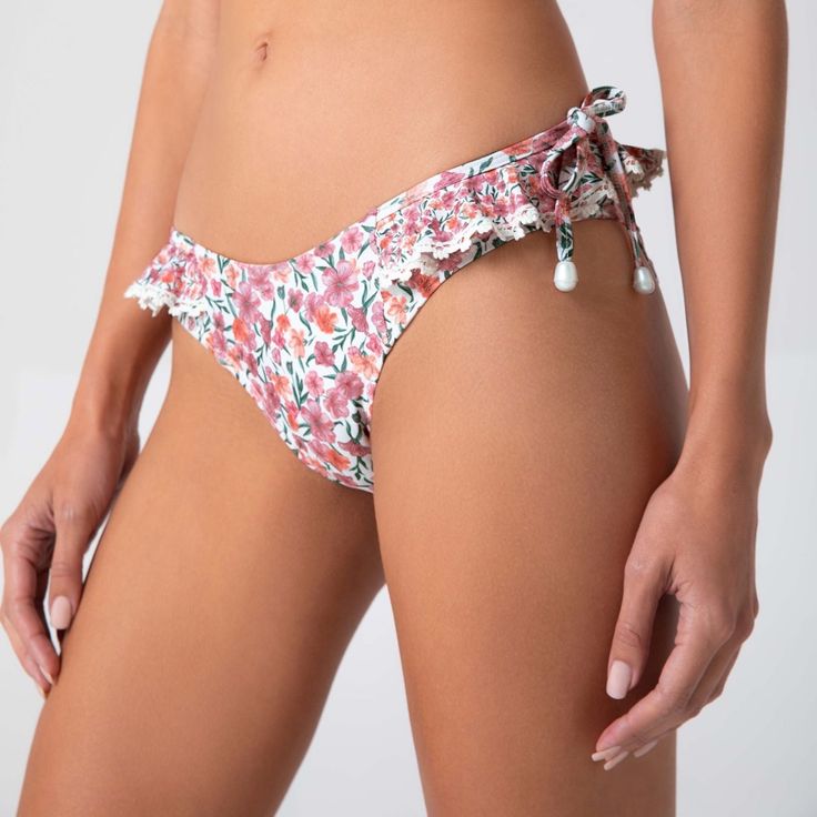 Bottom With Full Coverage Is A Flattering And Feminine Bikini Bottom. It Features A Low Rise, With Side Ruffle Detail For A Delightful Finish. Vacation Swimwear With Ruffles And Tie-side Bottom, Casual Ruffled Swimwear For Pool, Feminine Floral Print Swimwear For Sunbathing, Beachwear Swimwear With Ruffles And Tie-side Bottom, Feminine Floral Print Swimwear For Beach Season, Feminine Floral Swimwear For Beach Season, Feminine Printed Swimwear For Vacation, Feminine Printed Swimwear For Poolside, Feminine Floral Print Swimwear For Poolside