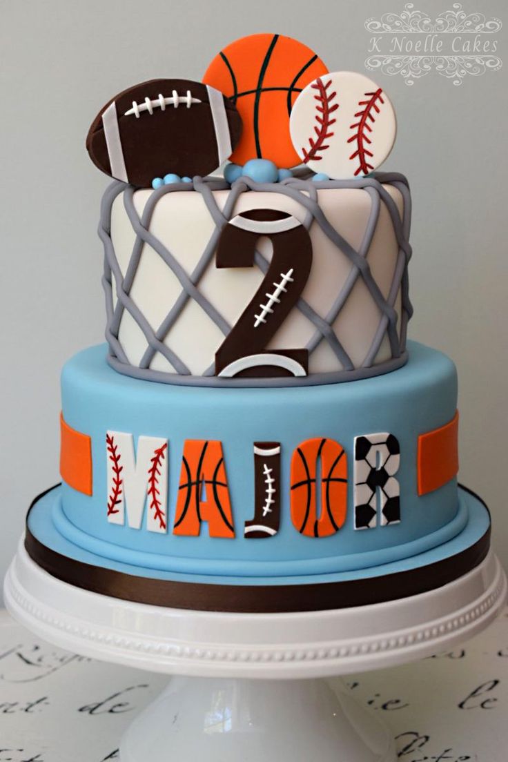 a three tiered cake decorated with sports balls and basketballs