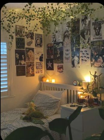 a bedroom with posters on the wall and lights in the corner, next to a bed