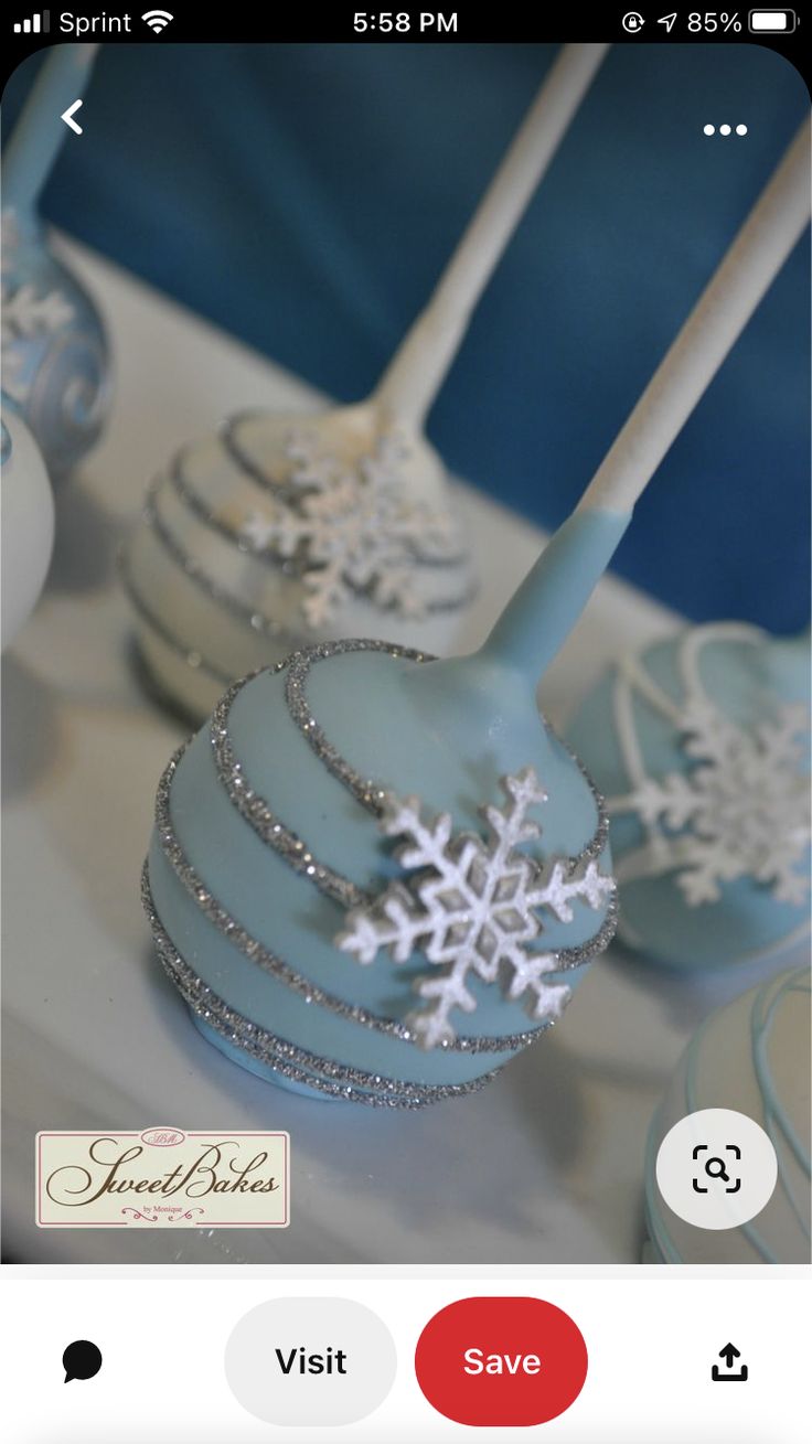 some cake pops with snowflakes on them