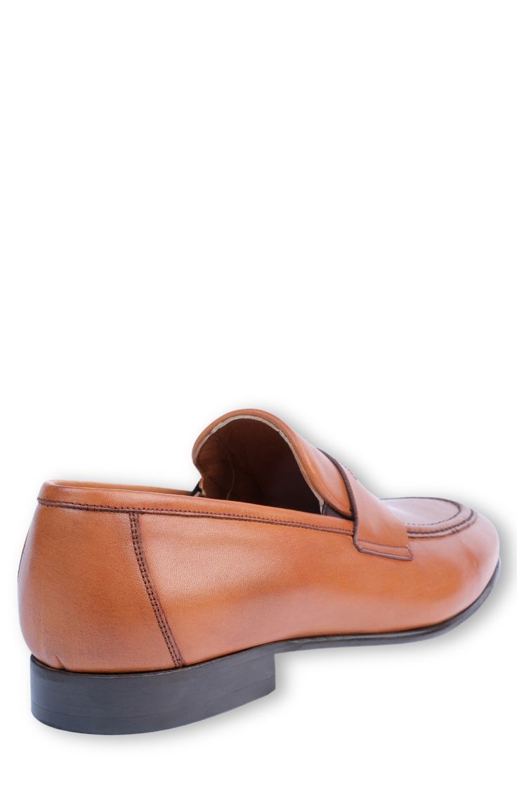 Handmade of smooth leather, this moc-toe dress shoe with a classic penny loafer silhouette offers a sophisticated, elegant look. Leather upper and lining/synthetic sole Made in Turkey Classic Cognac Slip-on Moccasins, Classic Cognac Leather Slip-on Shoes, Brown Semi-formal Loafers With Removable Insole, Classic Cognac Moc Toe Loafers, Elegant Cognac Slip-on Moccasins, Cognac Loafers With Leather Sole, Cognac Loafers With Moc Toe And Leather Sole, Cognac Loafers With Leather Sole And Plain Toe, Cognac Plain Toe Loafers With Leather Sole