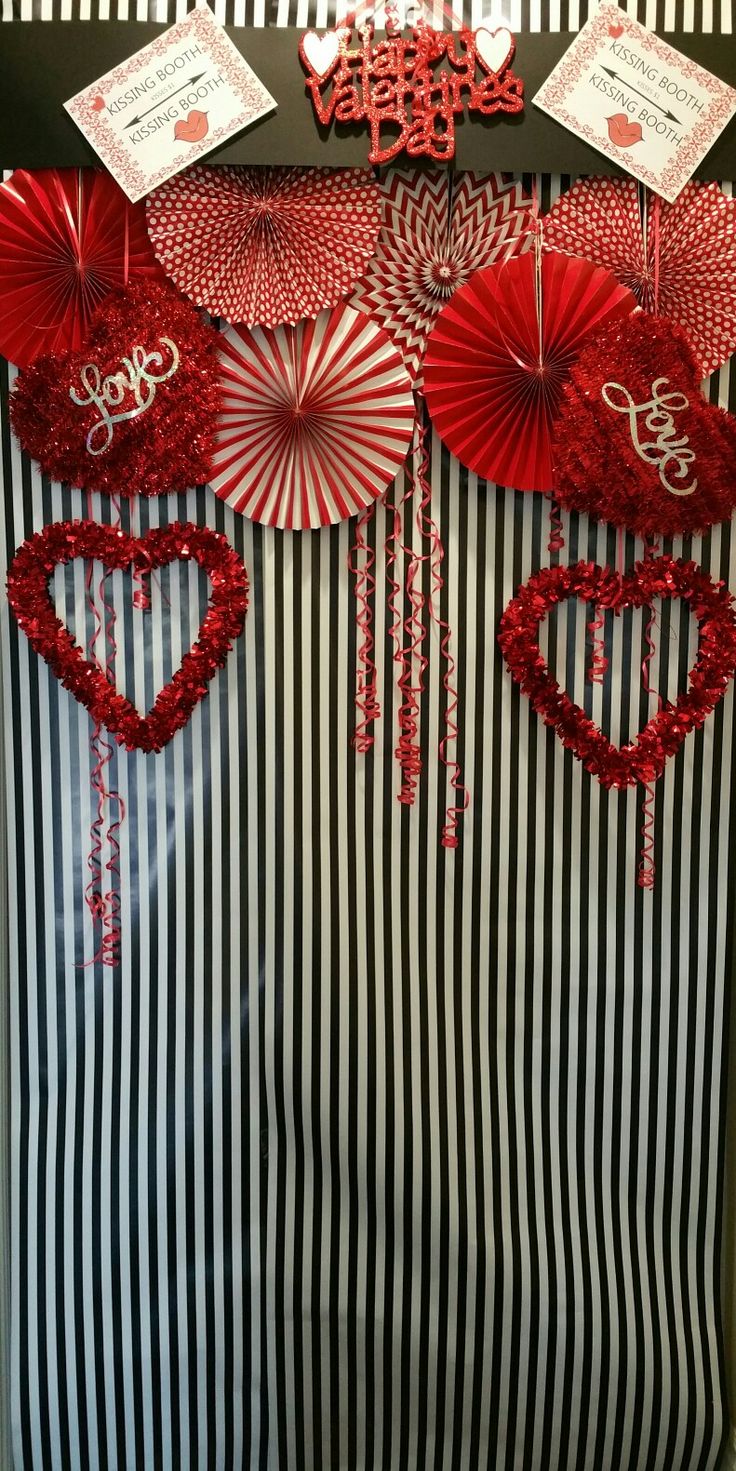 red and white paper decorations on display in a store window with black and white stripes