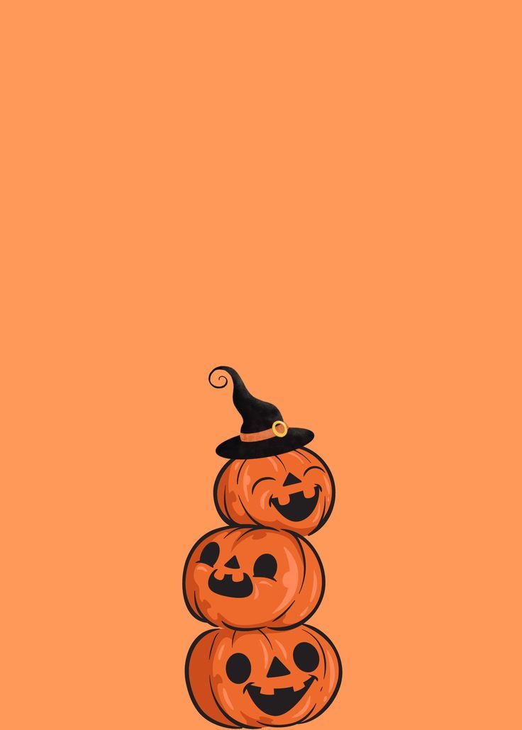 three pumpkins stacked on top of each other in front of an orange background with a black witches hat