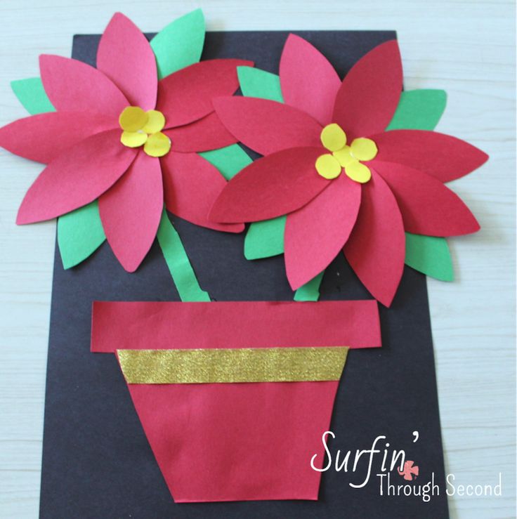 paper flowers in a flower pot made from construction paper on a black card board with gold foil