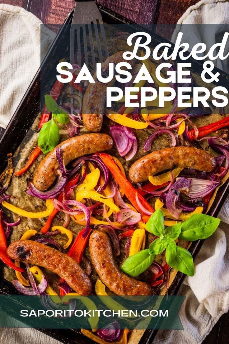 baked sausage and peppers in a baking pan with a fork on the side next to it